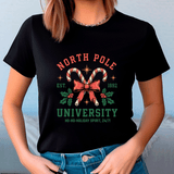 Person wearing a black t-shirt with Christmas-themed design and text.