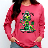 Person wearing a pink sweatshirt with a green character and text design.
