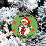 Christmas ornament with Santa Claus graphic and text 'YOU AIN'T GETTIN' SHIT' on a snow-covered tree.