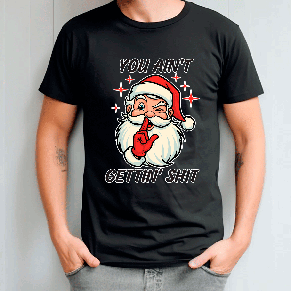 Black t-shirt with a graphic of Santa Claus and text, worn by a person.