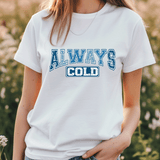 Person wearing a white t-shirt with 'ALWAYS COLD' text in blue outdoors.