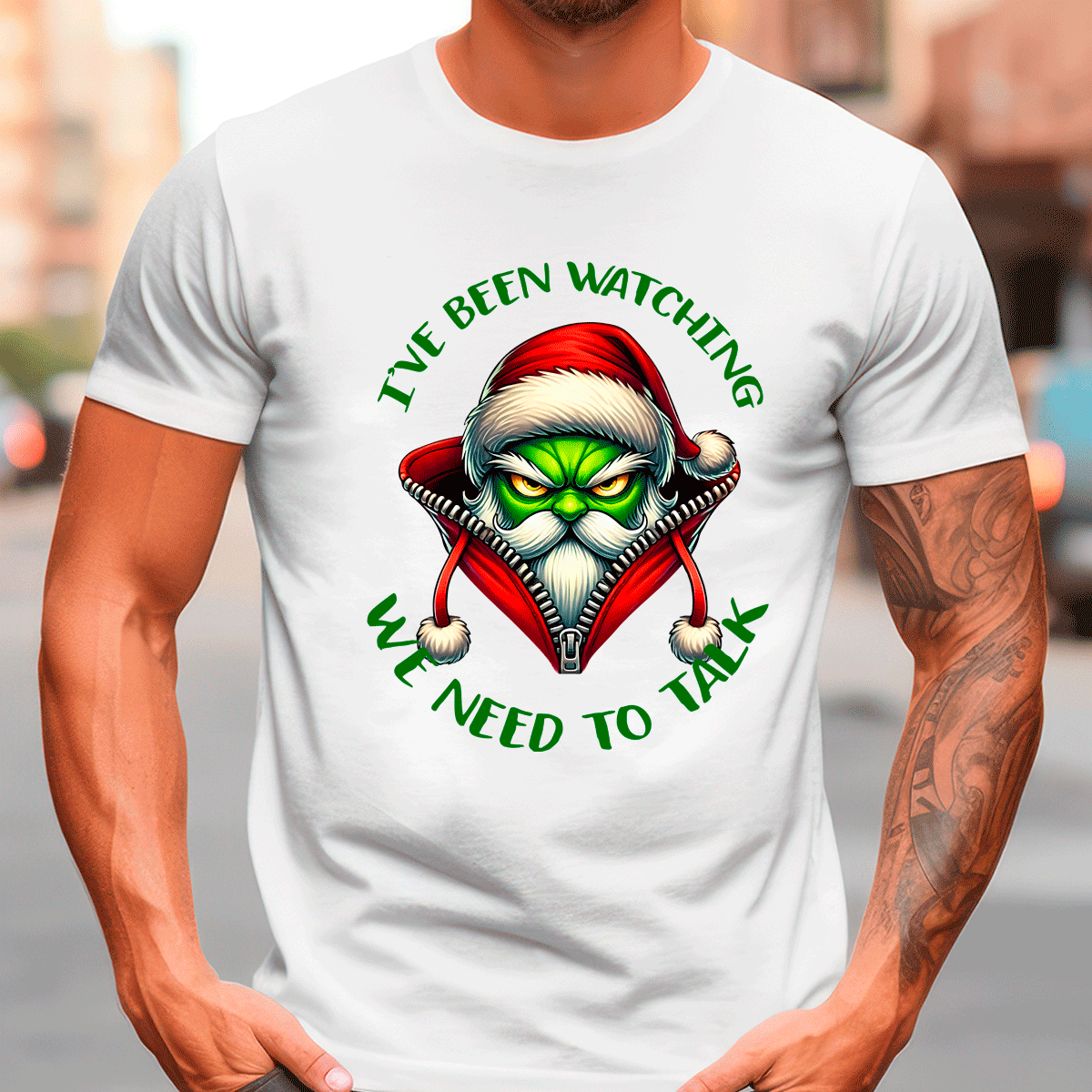 Person wearing a white t-shirt with a graphic design and text on a blurred street background