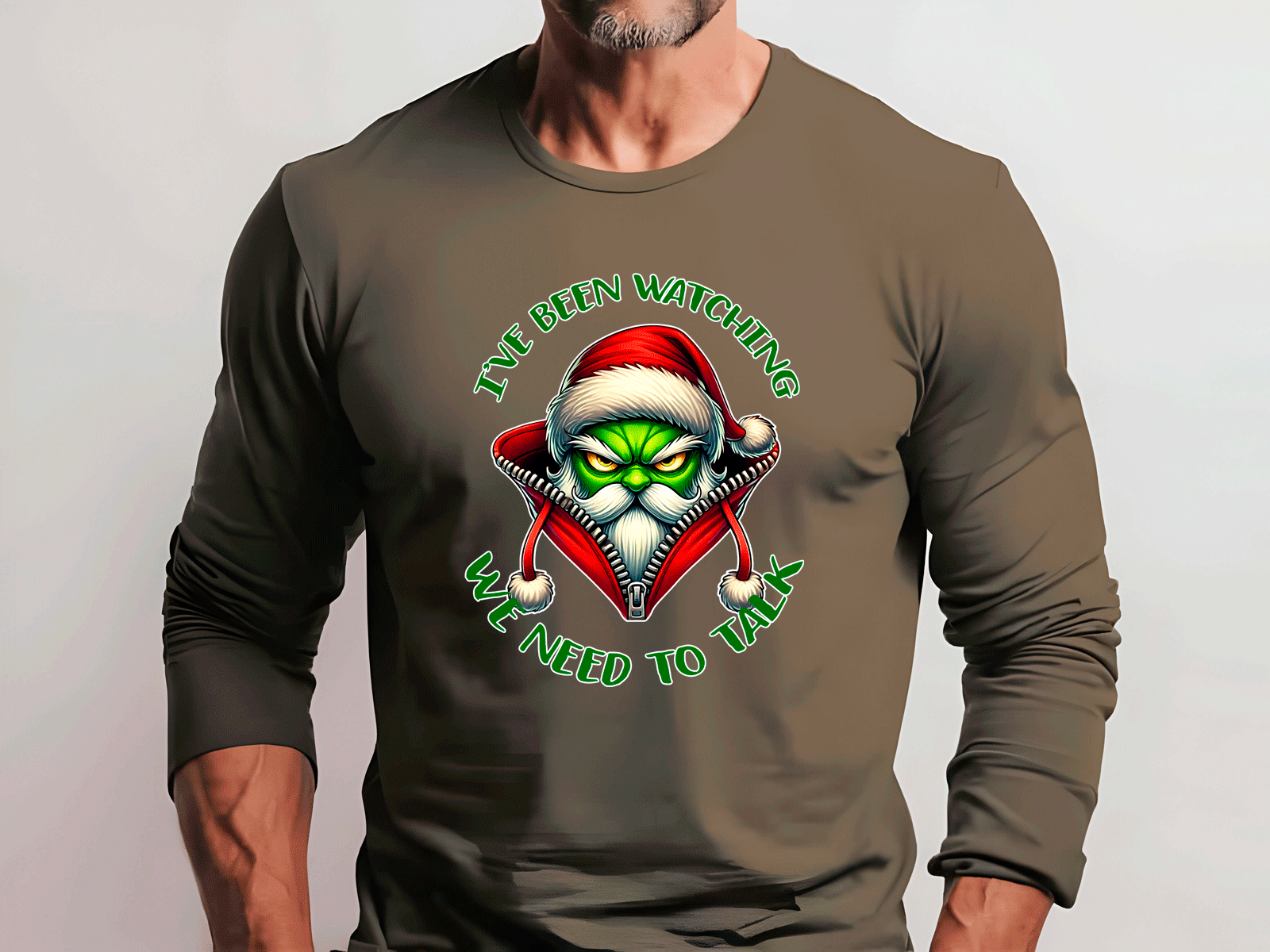 Brown long-sleeve shirt with a graphic design of a Santa Claus face and text on a plain background