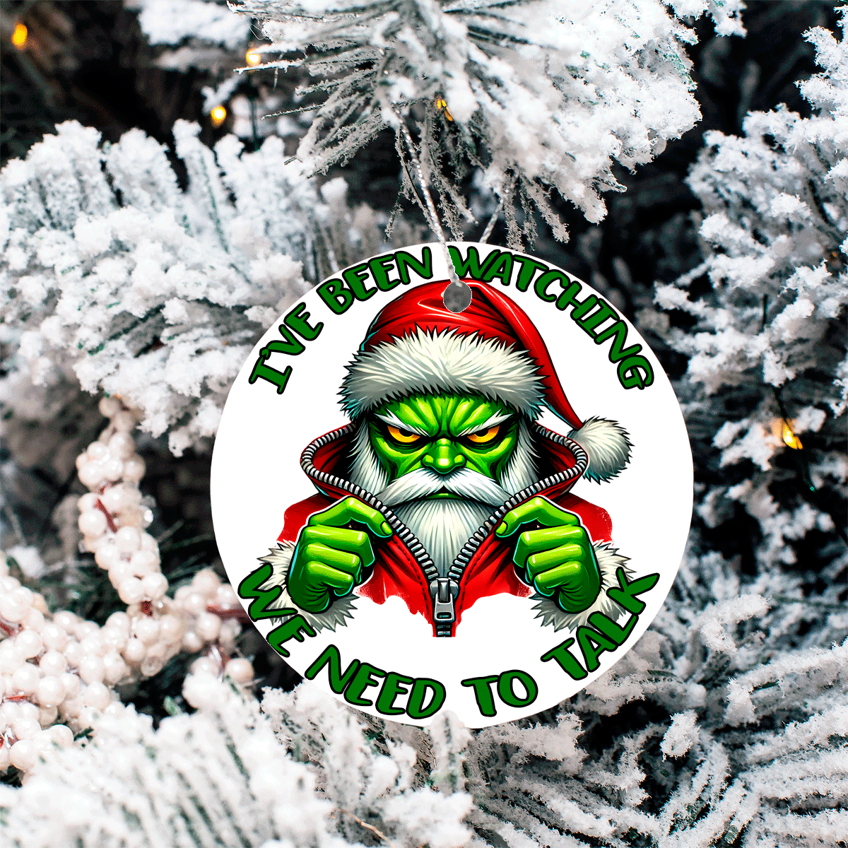 Christmas ornament with Grinch character and text 'I've been watching. We need to talk' on a snowy tree background.