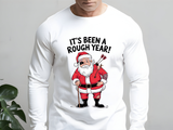 White long-sleeve shirt with a graphic of Santa Claus and text 'It's Been a Rough Year!' on a plain background.