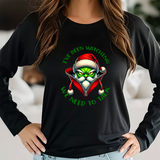 Black long-sleeve shirt with a graphic design of a character wearing a Santa hat and text, worn by a person.