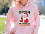 Person wearing a pink hoodie with a graphic design featuring Santa Claus and text.