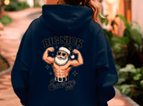 Person wearing a navy hoodie with a graphic design on the back, featuring a muscular figure in a Santa hat and sunglasses.