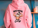 Pink hoodie with a graphic of a muscular Santa Claus and text 'BIG NICK Energy' on a blue background.