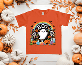 Orange t-shirt with Halloween-themed design featuring ghosts, pumpkins, and 'BOO' text, surrounded by pumpkins and leaves on a white background.