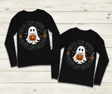 Black long-sleeve shirts with Halloween-themed design on a wooden surface