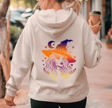 Person wearing a hoodie with a colorful witch graphic on the back, holding a coffee cup.