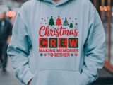 Light blue hoodie with Christmas-themed text and graphics worn by a person in an urban setting.