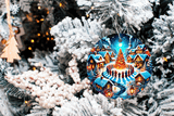 Decorative Christmas ornament with a village scene on a snow-covered tree