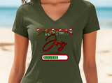 Person wearing a green t-shirt with 'Christmas Joy Loading' text on a beach background