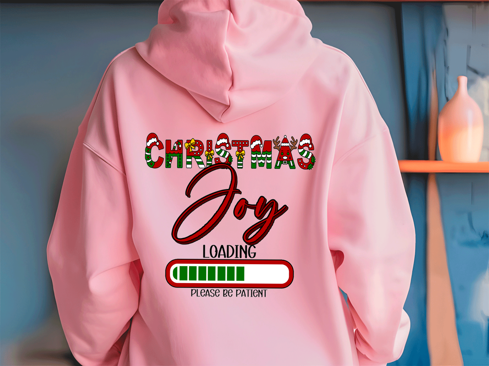 Pink hoodie with 'Christmas Joy Loading' text on a blue background