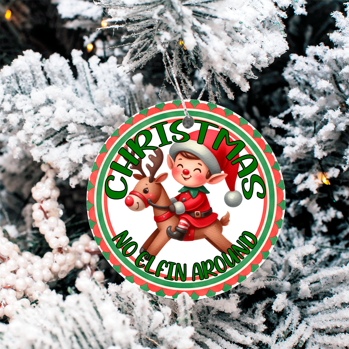 Christmas ornament with an elf and reindeer design hanging on a tree.