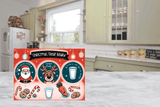 Christmas-themed cutting board  with Santa Claus and reindeer design on a kitchen floor.