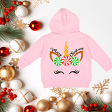 Pink hoodie with Christmas-themed design surrounded by festive decorations on a white background