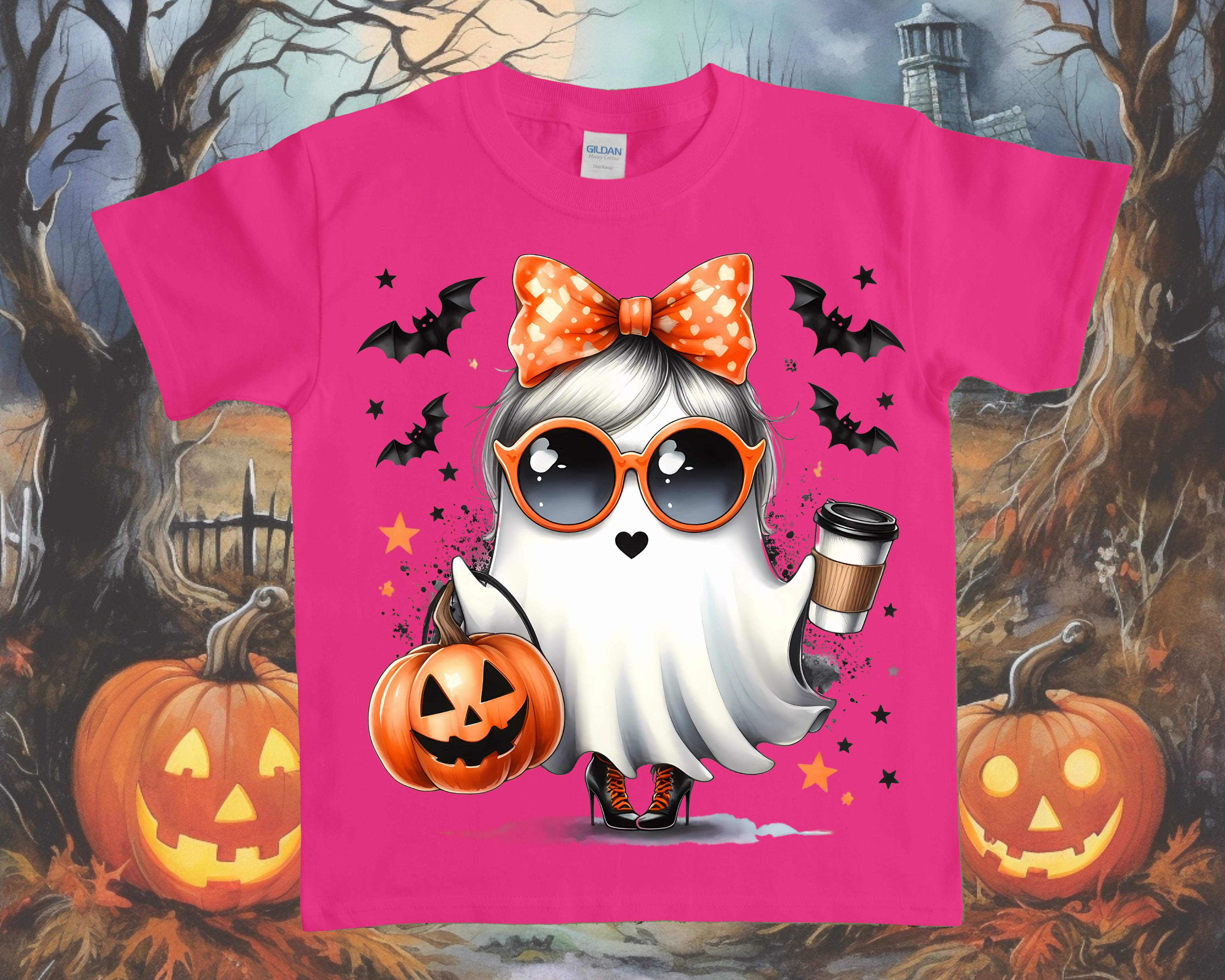 Pink t-shirt with a Halloween-themed design featuring a ghost, pumpkins, and bats on a spooky background.