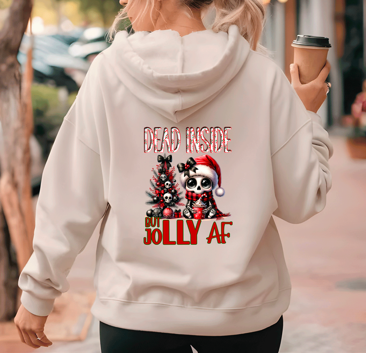 Person wearing a hoodie with Christmas-themed design and text.