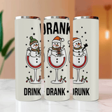 Three white tumblers with snowman designs and text on a light surface.