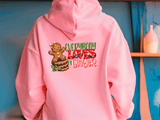 Pink hoodie with gingerbread design and text on a blue background
