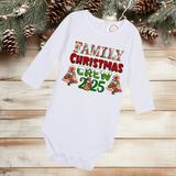 White long-sleeve baby onesie with 'Family Christmas Crew 2025' text and Christmas tree graphics on a wooden surface with pinecones and branches.