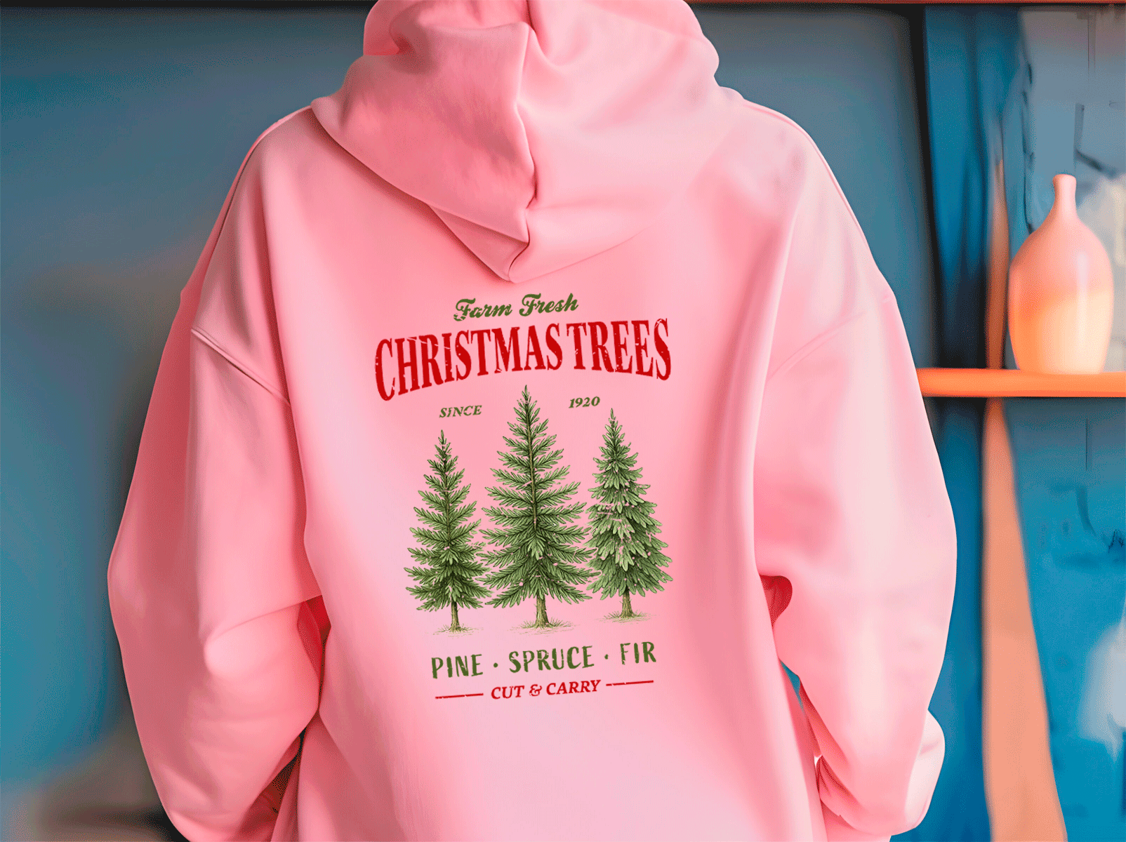 Pink hoodie with Christmas tree design and text on a blue background