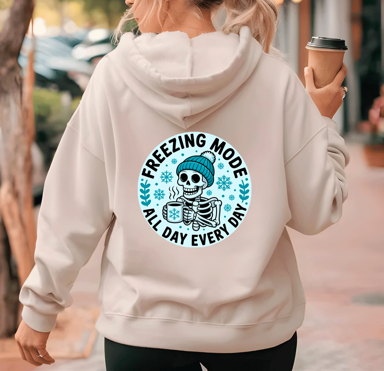 Person wearing a hoodie with a skeleton design and text 'Freezing Mode All Day Every Day' on the back.