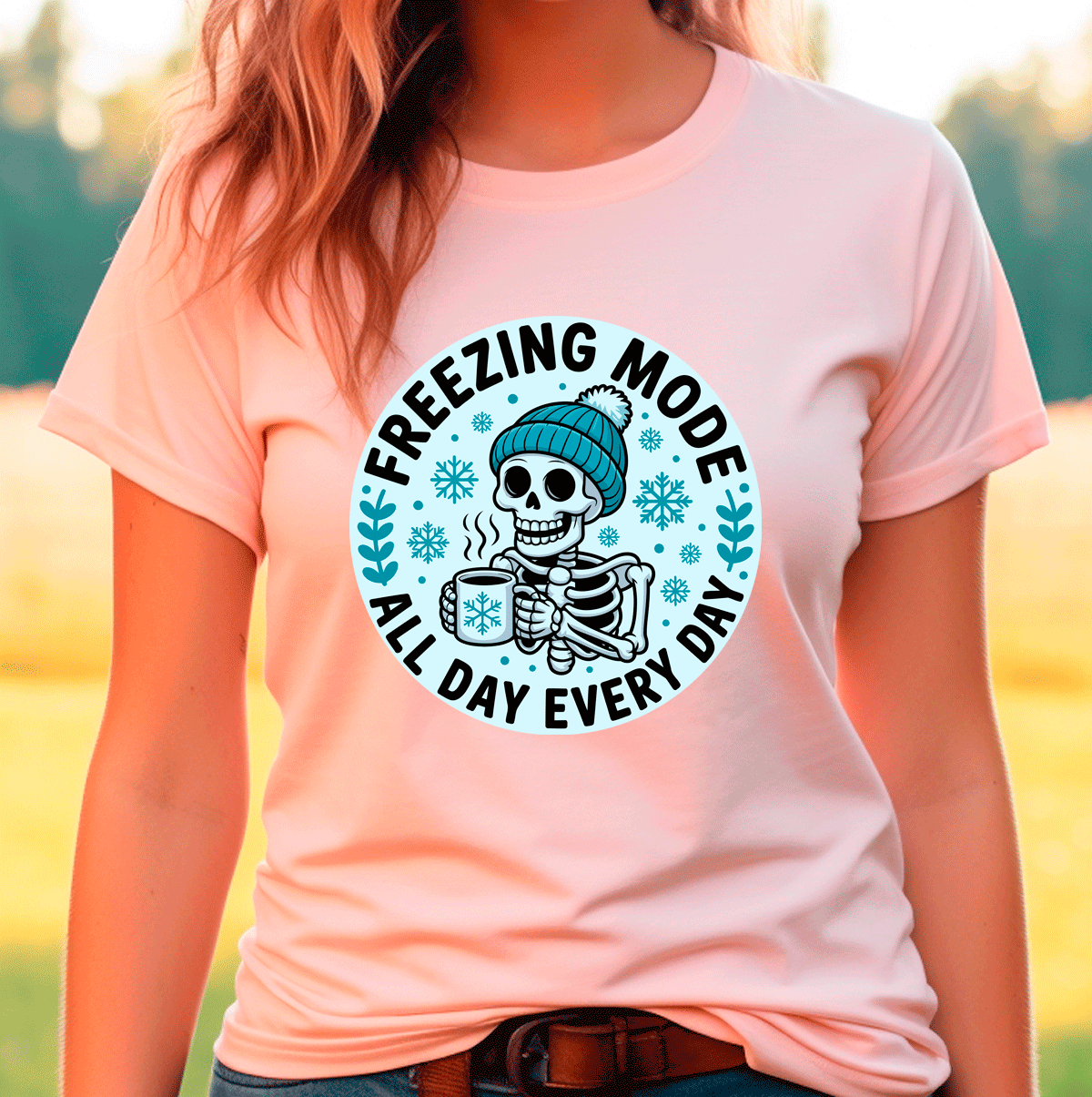 Person wearing a peach t-shirt with a skeleton graphic and 'Freezing Mode All Day Every Day' text.