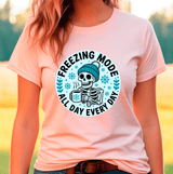 Person wearing a peach t-shirt with a skeleton graphic and 'Freezing Mode All Day Every Day' text.