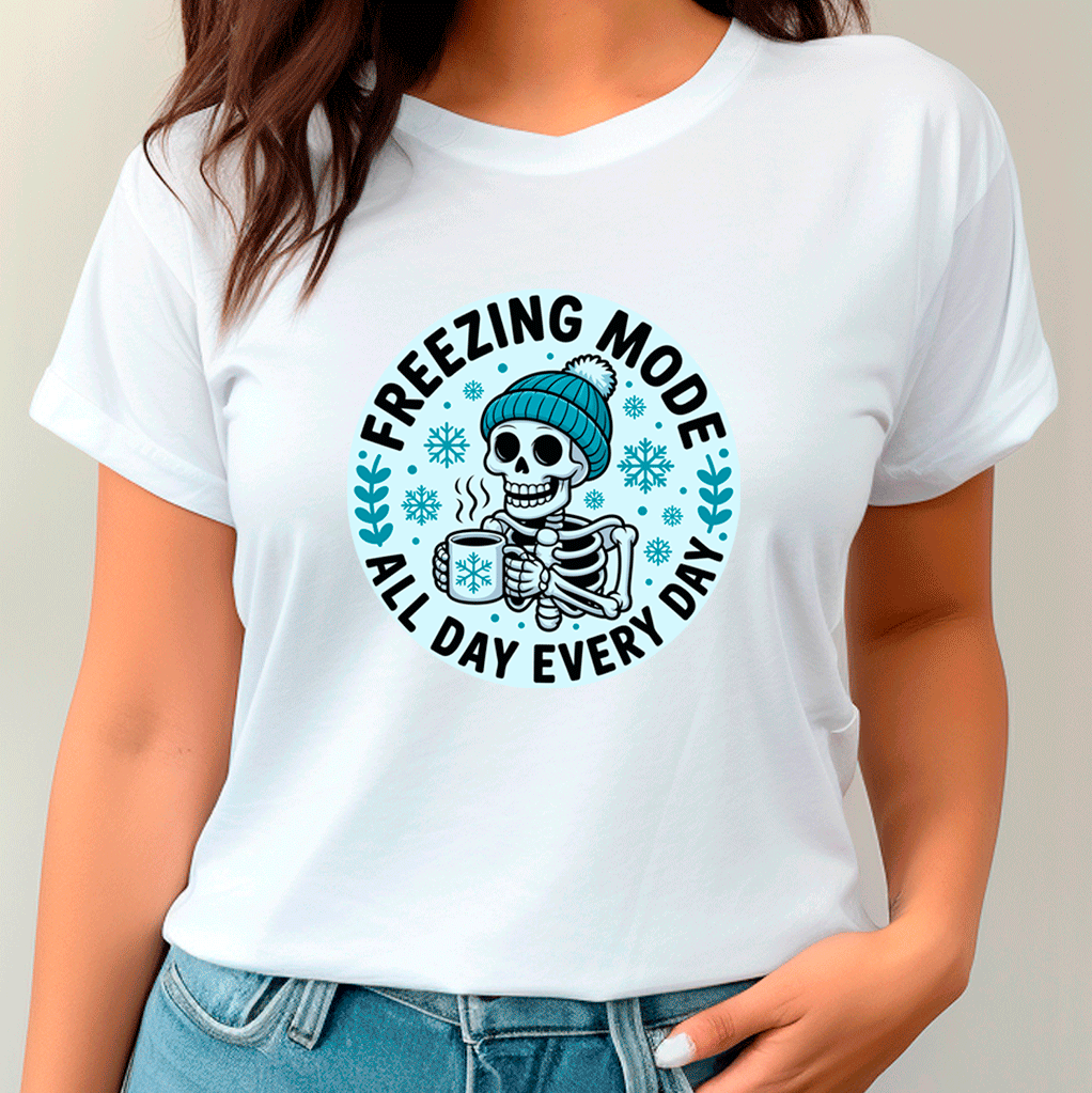 White t-shirt with a skeleton wearing a beanie and text 'Freezing Mode All Day Every Day' on a plain background