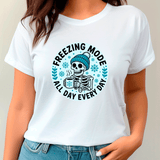 White t-shirt with a skeleton wearing a beanie and text 'Freezing Mode All Day Every Day' on a plain background