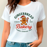 White t-shirt with gingerbread man design and text on a plain background