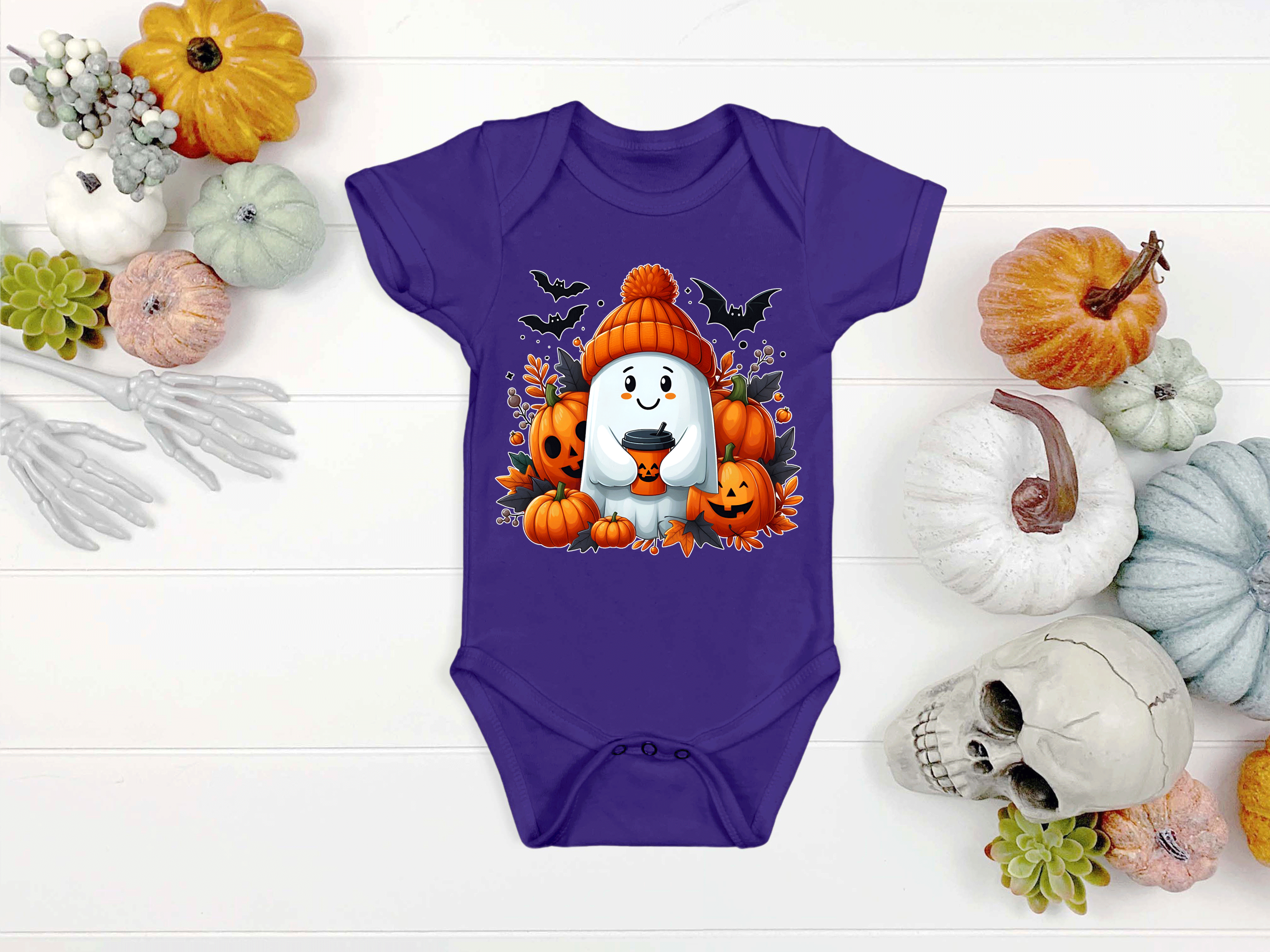 Purple baby onesie with Halloween-themed design on a white background with pumpkins and skulls.