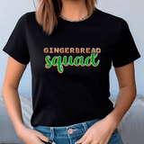 Person wearing a black t-shirt with 'GINGERBREAD SQUAD' text in colorful letters.