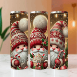 Three cylindrical tumbler designs featuring festive gnomes with winter hats and candy-themed decorations on a blurred background.