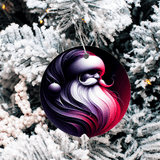 Decorative ornament with a colorful design hanging on a snow-covered tree.