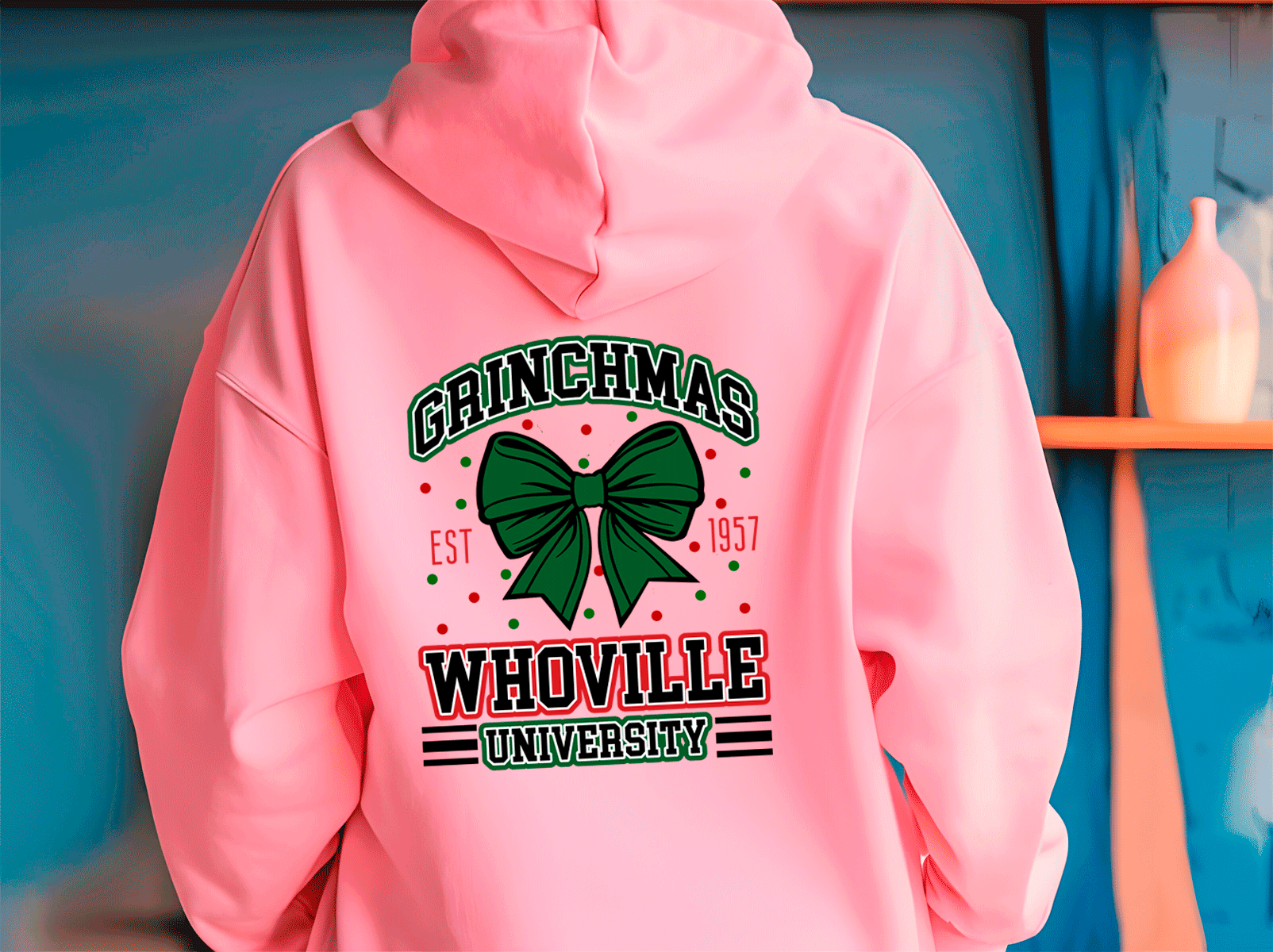 Pink hoodie with 'Grinchmas Whoville University' text and green bow design on a blue background.