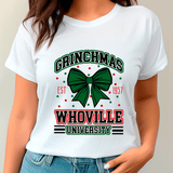 White t-shirt with 'Grinchmas Whoville University' design on a plain background