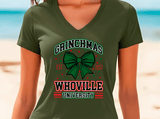 Person wearing a green t-shirt with 'Grinchmas Whoville University' design on a beach.