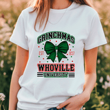Person wearing a white t-shirt with 'Grinchmas Whoville University' design outdoors.
