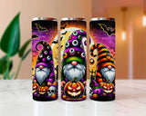Three Halloween-themed tumblers with gnomes and pumpkins on a white surface.