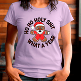 Person wearing a purple t-shirt with a Christmas-themed graphic and text.