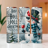Three Christmas-themed tumblers with snowman and holiday designs on a wooden surface.