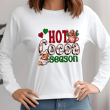 White sweatshirt with 'Hot Cocoa Season' graphic design on a plain background