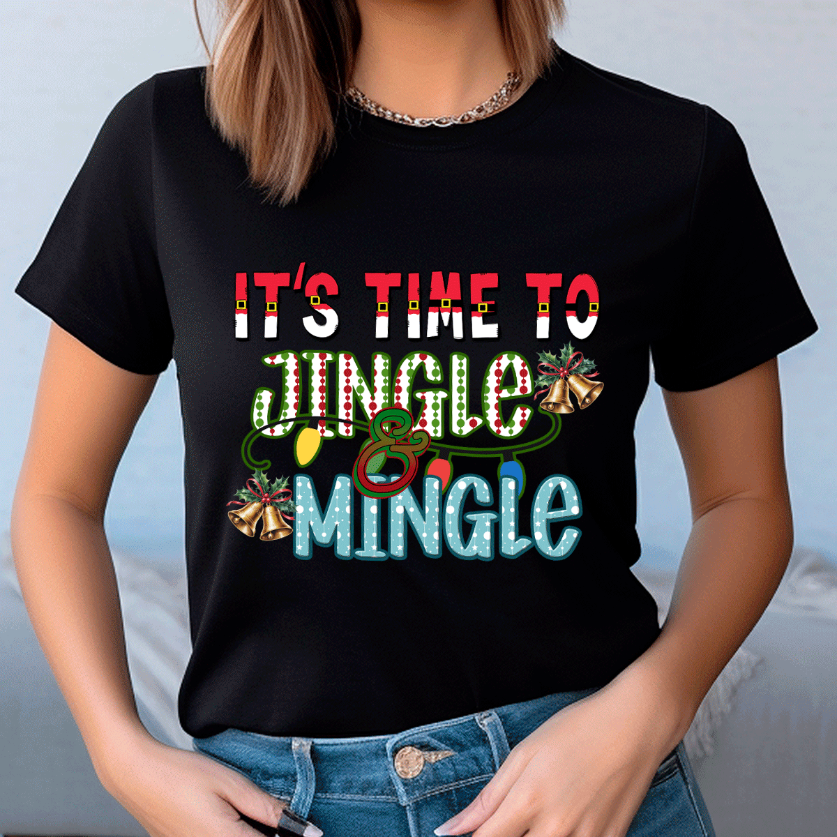 Person wearing a black t-shirt with festive text and graphics.