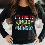 Black long-sleeve shirt with colorful text and graphics, worn by a person indoors.