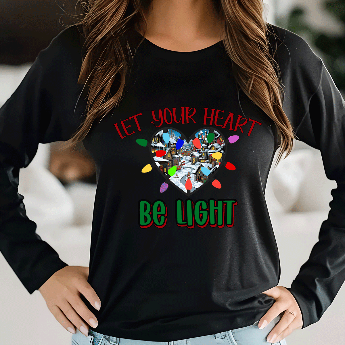 Person wearing a black long-sleeve shirt with a colorful heart design and text.